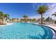 Resort-style pool with palm trees and lounge chairs at 8939 Coconut Breeze Dr, Kissimmee, FL 34747