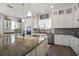Modern kitchen featuring granite countertops and white cabinetry at 1379 Kiawah St, Celebration, FL 34747