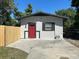 Cute cottage with red door and small front yard at 221 N Julia Ave, Deland, FL 32720