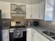 Modern kitchen features stainless steel appliances and granite countertops at 221 N Julia Ave, Deland, FL 32720