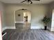 Open living room with hardwood floors and arched doorways at 221 N Julia Ave, Deland, FL 32720