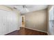 Bedroom with double door closet and wood floors at 2441 Derby Dr, Deltona, FL 32738