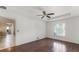 Well-lit bedroom with wood floors and access to the kitchen at 2441 Derby Dr, Deltona, FL 32738