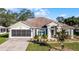 Single-story house with a two-car garage and landscaped front yard at 2441 Derby Dr, Deltona, FL 32738