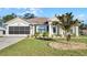 Single-story house with a two-car garage and landscaped front yard at 2441 Derby Dr, Deltona, FL 32738