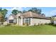 Single-story house with a two-car garage and landscaped front yard at 2441 Derby Dr, Deltona, FL 32738