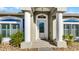 Front entrance with white door and columns at 2441 Derby Dr, Deltona, FL 32738