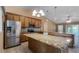 Kitchen features granite countertops, stainless steel appliances, and wood cabinets at 2441 Derby Dr, Deltona, FL 32738
