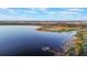 Aerial view of a peaceful lakefront community with a dock at 2609 Mead Ave, St Cloud, FL 34771