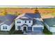 Two-story house with gray siding and a blue garage door, viewed from above at 2609 Mead Ave, St Cloud, FL 34771