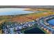 Aerial view of a lakefront community with luxury homes and walking trails at 2609 Mead Ave, St Cloud, FL 34771