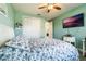 Bedroom with white dresser, ceiling fan, and floral bedding at 2609 Mead Ave, St Cloud, FL 34771