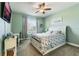 Bedroom with window, ceiling fan and white bed at 2609 Mead Ave, St Cloud, FL 34771
