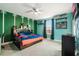 Youth bedroom with a football-themed wall and comfy bed at 2609 Mead Ave, St Cloud, FL 34771
