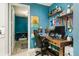 Bright home office features a wood desk, two monitors, and built-in shelving at 2609 Mead Ave, St Cloud, FL 34771