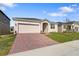 One story home with attached garage and manicured lawn at 2740 Sweet Acacia Dr, Clermont, FL 34711