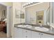 Double vanity bathroom with granite countertop and a large mirror at 404 Brunello Dr, Davenport, FL 33897