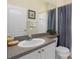 Bathroom with single sink, shower/tub combo, and granite countertop at 404 Brunello Dr, Davenport, FL 33897