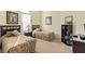 Guest bedroom with two twin beds, nightstands, and a bookcase at 404 Brunello Dr, Davenport, FL 33897