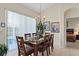 Dining room with table and chairs, view of pool through window at 404 Brunello Dr, Davenport, FL 33897