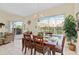 Bright dining room with table, chairs, and access to pool view at 404 Brunello Dr, Davenport, FL 33897