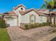 Front view of charming villa with brick driveway and landscaping at 404 Brunello Dr, Davenport, FL 33897