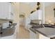 Kitchen features white cabinets, granite countertops, and stainless steel appliances at 404 Brunello Dr, Davenport, FL 33897