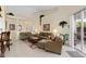 Open and bright living room with tiled floors and patio access at 404 Brunello Dr, Davenport, FL 33897