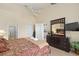 King bedroom with large TV, ensuite bathroom, and walk-in closet at 404 Brunello Dr, Davenport, FL 33897