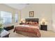 Main bedroom with king-size bed and ensuite bathroom access at 404 Brunello Dr, Davenport, FL 33897