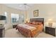 Spacious main bedroom with king bed, two nightstands, and a large window at 404 Brunello Dr, Davenport, FL 33897