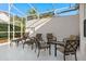 Relaxing patio with seating area under screened enclosure at 404 Brunello Dr, Davenport, FL 33897