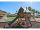 Community playground with shaded playset, slide, climbing wall, and swings at 404 Brunello Dr, Davenport, FL 33897