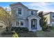 Two-story house with gray siding, brick walkway, and landscaping at 5189 Northlawn Way, Orlando, FL 32811