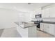 Modern kitchen with stainless steel appliances and granite countertops at 520 Kennedy Dr, Lake Alfred, FL 33850