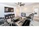 Relaxing living area with black reclining sofas, a media console, and a ceiling fan at 678 Fiddlesticks Dr, Davenport, FL 33837