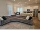 Open concept living area with sectional sofa and modern kitchen at 7309 Tidepool Pl, Celebration, FL 34747