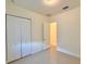Well-lit bedroom featuring neutral walls and double door closet at 8227 Vineland Oaks Blvd, Orlando, FL 32835