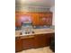 Galley kitchen with wood cabinets and updated appliances at 1111 N Brunnell Pkwy, Lakeland, FL 33805