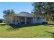 House's backyard features a large covered patio and green lawn at 1178 Black Walnut Ct, Winter Springs, FL 32708