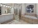 Bathroom features a glass block partition, soaking tub, and vanity at 1178 Black Walnut Ct, Winter Springs, FL 32708