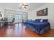 Main bedroom with king-size bed, home office, and access to a balcony at 1178 Black Walnut Ct, Winter Springs, FL 32708