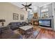 Relaxing living room with a fireplace, hardwood floors, and large TV at 1178 Black Walnut Ct, Winter Springs, FL 32708