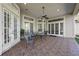 Covered patio features tile flooring, ceiling fan and comfortable seating area at 1178 Black Walnut Ct, Winter Springs, FL 32708