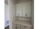 White cabinets and quartz countertops in a kitchen pantry at 15086 Summer Harvest St, Winter Garden, FL 34787