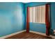 Empty bedroom with blue walls and hardwood floors at 1930 Conway Rd # 2, Orlando, FL 32812