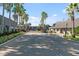 Gated community entrance with palm trees and landscaping at 1930 Conway Rd # 2, Orlando, FL 32812