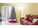 Living room with a decorated Christmas tree and brown leather couch at 1930 Conway Rd # 2, Orlando, FL 32812