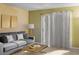Living room with gray couch, coffee table, and access to patio at 1930 Conway Rd # 2, Orlando, FL 32812