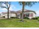 House exterior showcasing landscaping, a three-car garage and walkway at 2572 Squaw Crk, Clermont, FL 34711